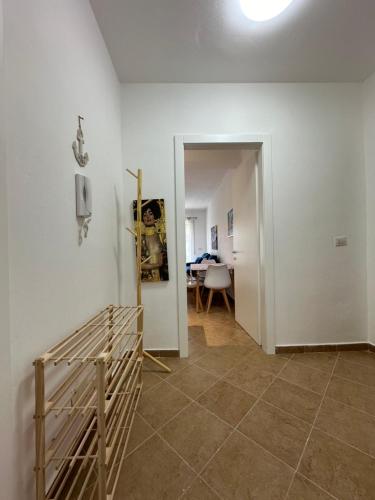 a hallway with a room with a crib and a phone at Joni's Twin Condos (Pool&Pine View) in Golem
