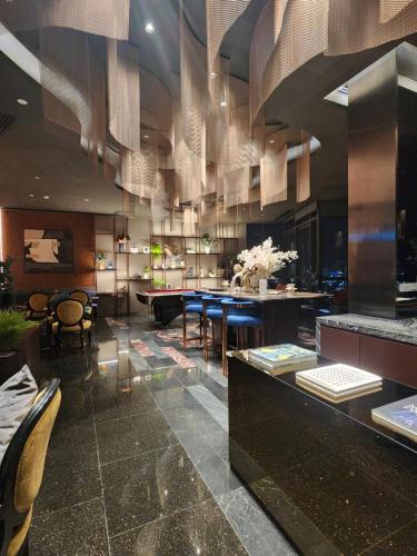 a lobby with a dining room with tables and chairs at The Edge Central Pattaya - Unique & Luxurious in Pattaya Central