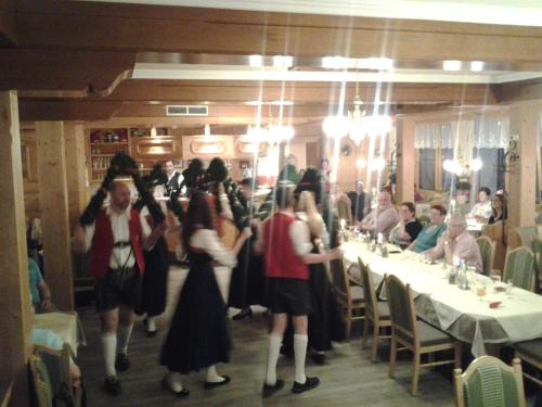 a group of people standing in a restaurant at Aktiv-Hotel Traube am Mieminger Sonnenplateau in Wildermieming