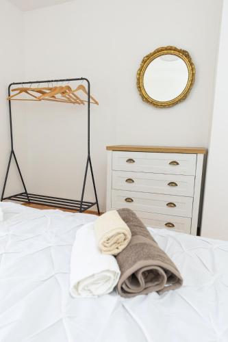 a bedroom with a bed with a mirror and a dresser at Villa Mellifera in Grohote