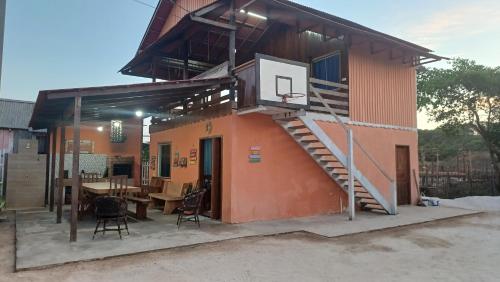 a house with a basketball hoop on top of it at Casa Ajuruteua Meu Paraíso in Bragança
