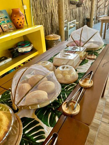 a table with plates of food and spoons on it at The Jungle, Village & Beach in Guriú