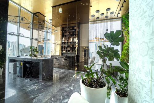 a lobby with plants in pots in a building at Exclusive and Luxurious 2BR at Wanders & Yoo in Panama City