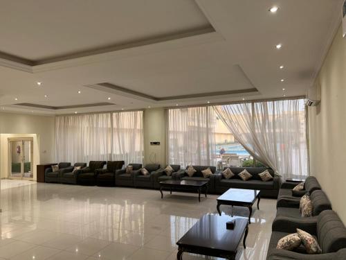 a large living room with couches and tables at الصواري ريزدينس in Jeddah