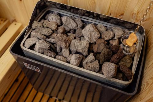 a container of rocks sitting on a grill at *NEW IN 2025* - Hotel Subra Atrium in Herceg-Novi