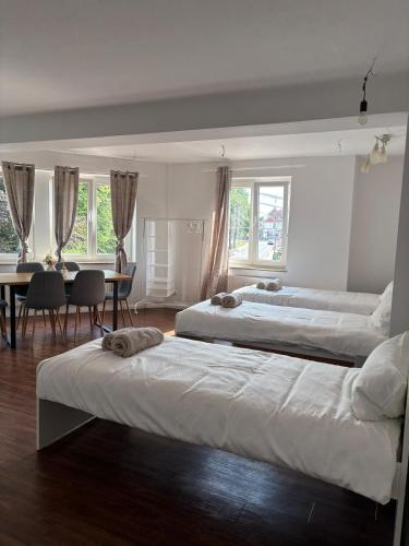 a bedroom with two beds and a table and chairs at Monteurswohnung Lingen in Lingen