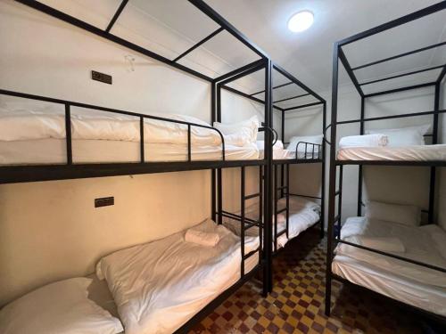a room with three bunk beds in a room at 里院 Daoudiate courtyard in Marrakech