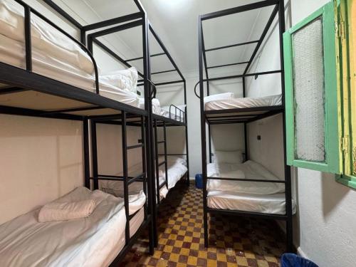 a room with three bunk beds in a dorm room at 里院 Daoudiate courtyard in Marrakech