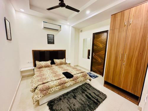 a bedroom with a bed and a wooden cabinet at Prahar Homes in Jāmb