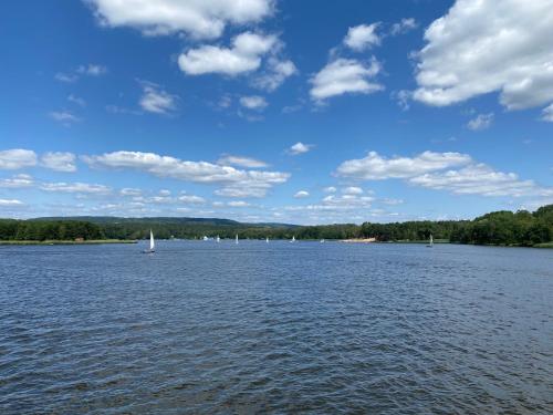 a large body of water with sailboats on it at Family & Business Sauna Apartments No 6 Leśny nad Zalewem Cedzyna - 1 Bedroom with Private Sauna, Terrace, Parking, Catering Options in Kielce