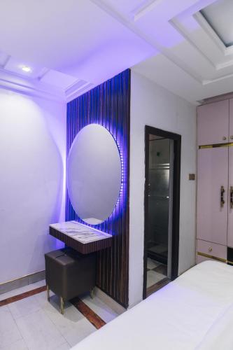 a bedroom with a large mirror and a bed at Another Home Hotels ltd in Owerri