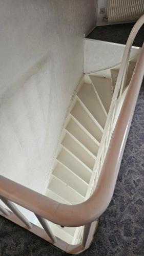 a white stair case in a room at ANTWERPSESTRAAT Tomorrowland in Boom in Boom
