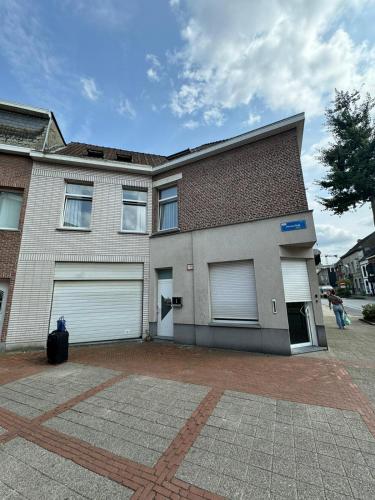 a large house with two garage doors on it at ANTWERPSESTRAAT Tomorrowland in Boom in Boom