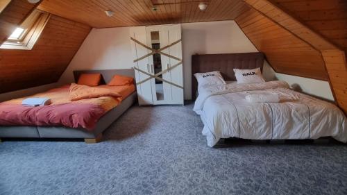 a bedroom with two beds and a cross on the wall at ANTWERPSESTRAAT Tomorrowland in Boom in Boom