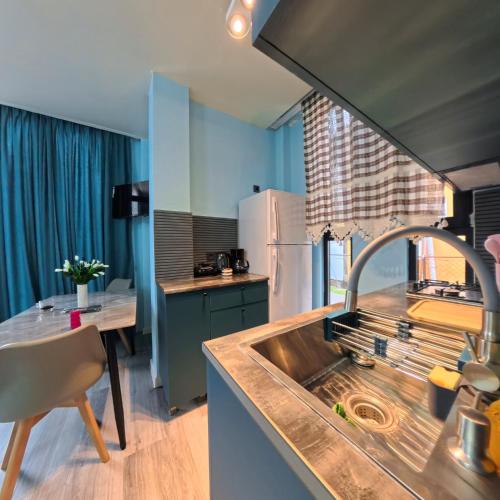 a kitchen with a sink and a table with a dining room at Premium apartment in Ureki