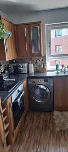 a kitchen with a washer and a dishwasher at Musselburgh Flat in Musselburgh