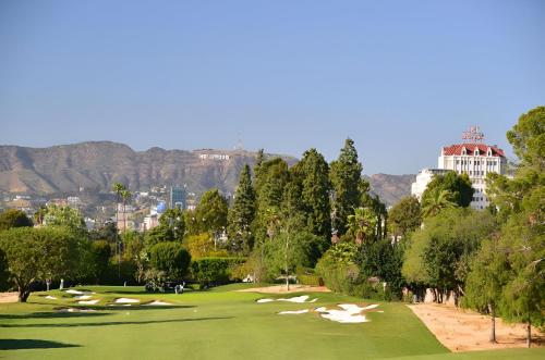 a view of a golf course with mountains in the background at Luxurious Hollywood Home City View - Free Parking 10mins to Universal Studios in Los Angeles
