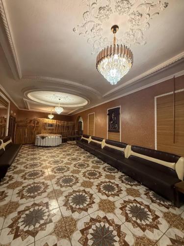 a ballroom with a chandelier and a large room with a large floor at Sadyba Pidkova Чан сауна Приймаємо групи до 70людей in Pistyn