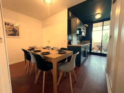 une salle à manger avec une table et des chaises et une cuisine dans l'établissement Appartement Toulouse Lautrec, à Albi