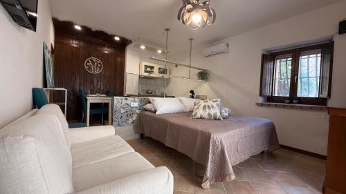 a living room with a bed and a couch at Casa MaNà in Trevi