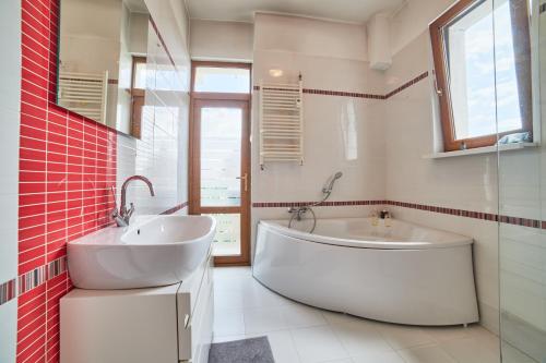 a bathroom with a large tub and a sink at Main Street Sunshine 2 KING Bdr in Sofia
