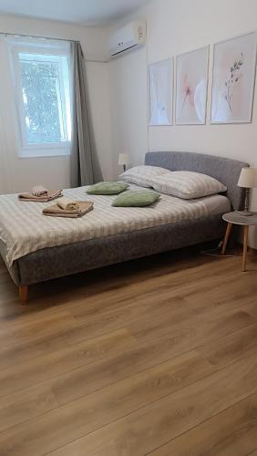 a large bed in a room with a wooden floor at Apartments Olivia in Pula