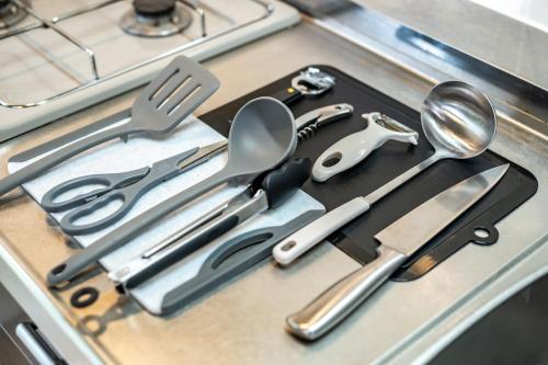 a bunch of kitchen utensils sitting on a counter at 貸切温泉宿 Shiny inn Kirishimaシャイニーイン霧島 in Kirishima