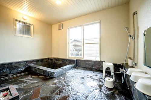 a bathroom with two sinks and a large window at 貸切温泉宿 Shiny inn Kirishimaシャイニーイン霧島 in Kirishima
