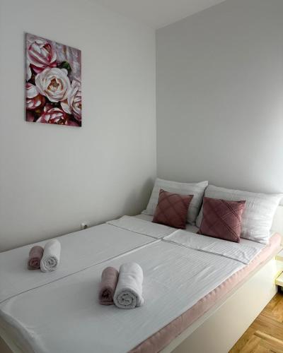 a bed with towels on it in a room at Apartments Sarajevo Nova Otoka in Sarajevo