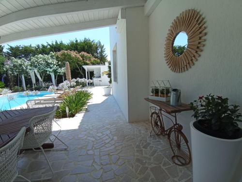 a patio with a table and a mirror on the wall at Tenuta viale degli ulivi in San Martino in Pensilis