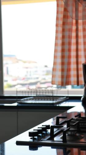 a close up of a stove top with a window at work&relax in Praia