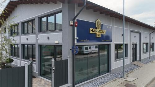 a building with a sign on the side of it at Harmony B&B in Fălticeni
