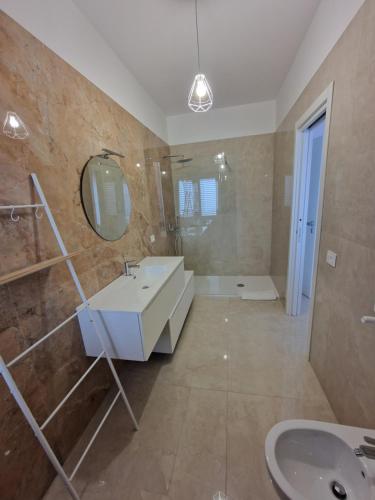 a bathroom with a sink and a mirror at Le stanze di Anna in Grottole
