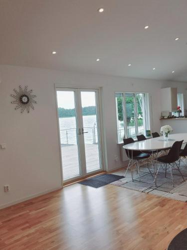 an empty living room with a table and chairs at Villa Solsa in Nynäshamn