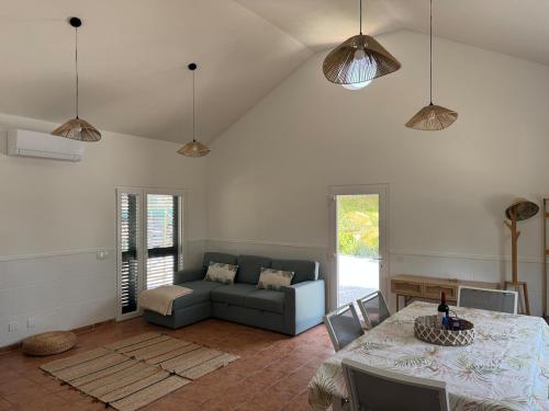 a living room with a couch and a table at Casa dos Sobreiros in Palmela