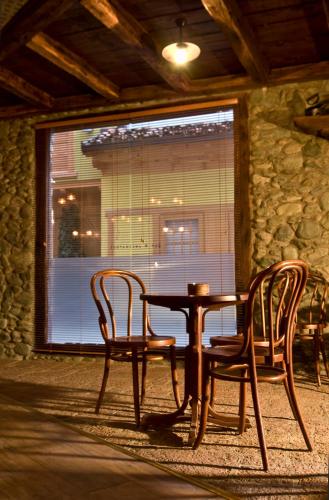 a table and chairs in a room with a window at Hotel Çarshia e Jupave in Gjakove