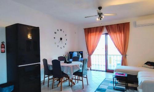 a living room with a table and chairs and a bedroom at Apartments Grbac Veli Rat-Seaside in Veli Rat
