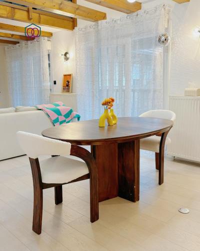 a wooden table and chairs in a living room at Chez Maya - Triplex cosy proche gare in Strasbourg