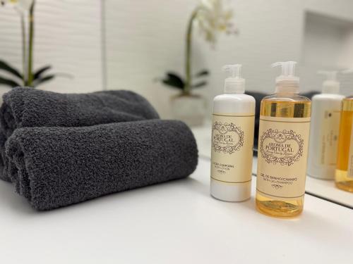 zwei Flaschen ätherischer Öle auf einer Badezimmerablage in der Unterkunft Casa do Lago das Freiras in Ribeira Grande