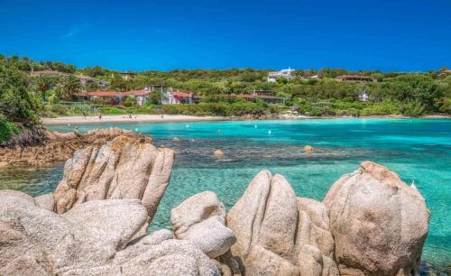 a view of a beach with rocks in the water at Good vibes apartment Portocervo marina in Porto Cervo