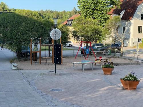 a park with a playground with benches and swings at ICRE lgh15 in Överum