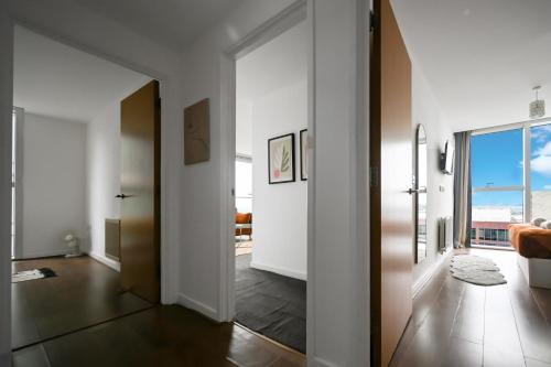 a hallway with a door leading to a living room at Blue Diamond in Milton Keynes