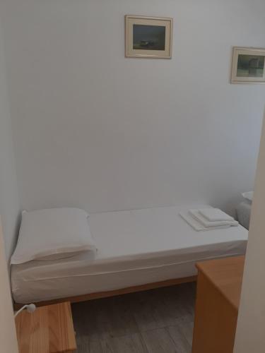 a bed in a room with a picture on the wall at SEA YA - two apartments house with heated pool - 150m from beach in Zaglavice