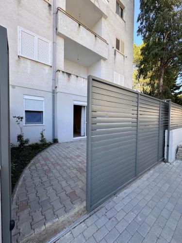 a metal garage door in front of a building at IRIA Apartment 1 & 2 in Golem