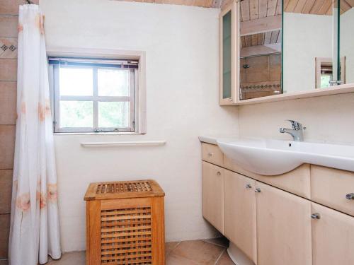 a bathroom with a sink and a window at 5 person holiday home in Ringkøbing-By Traum in Nørby
