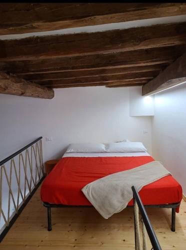 a bedroom with a bed with a red blanket at Appartamento Nonno Pit, Marettimo in Marettimo