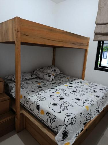 a bedroom with a bed with a wooden bed frame at Penginapan, homestay Gor Ken Arok kota malang jawa timur bisa 5-10 orang cocok bagi yg mau ke Bromo dan sekitarnya in Bareng