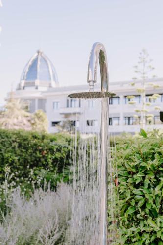 a water fountain in the middle of a garden at Aldi Seaside Suite in Athens