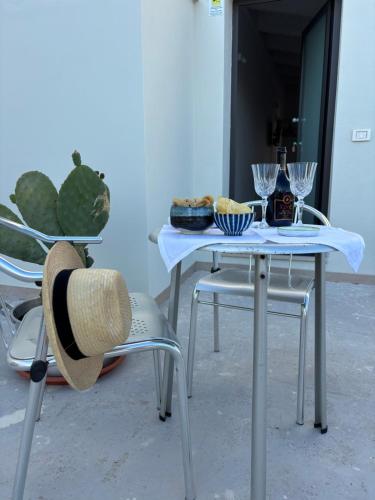 a table with a plate of food and glasses on it at VISCHI Roof con TERRAZZO e vista in Trani