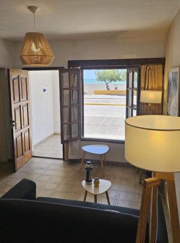a living room with a view of the ocean at Lōla Beach House - Playa Unión in Playa Unión